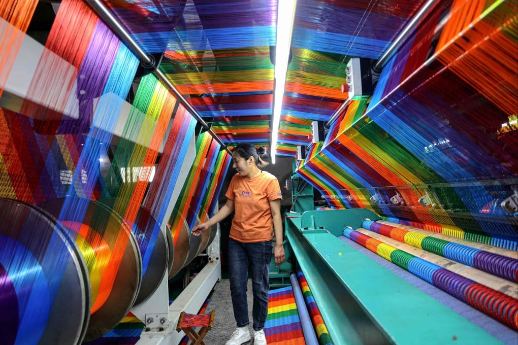 An employee works at a textile factory in Binzhou in Shandong province on May 14. Photo: AFP