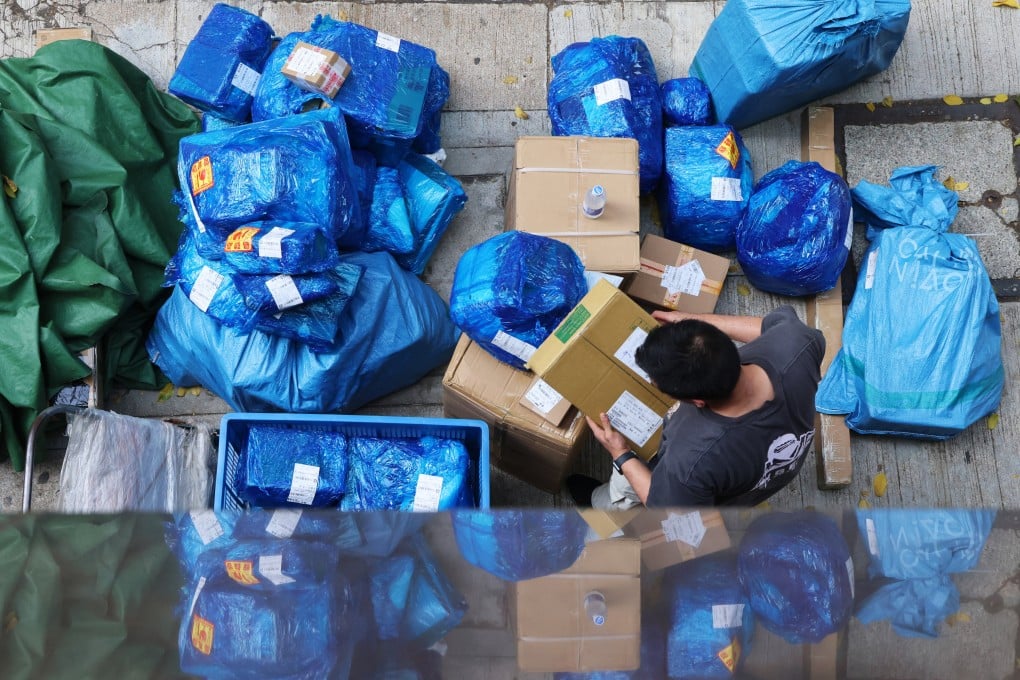 A courier worker sorts parcels in Wan Chai. Photo: Jelly Tse