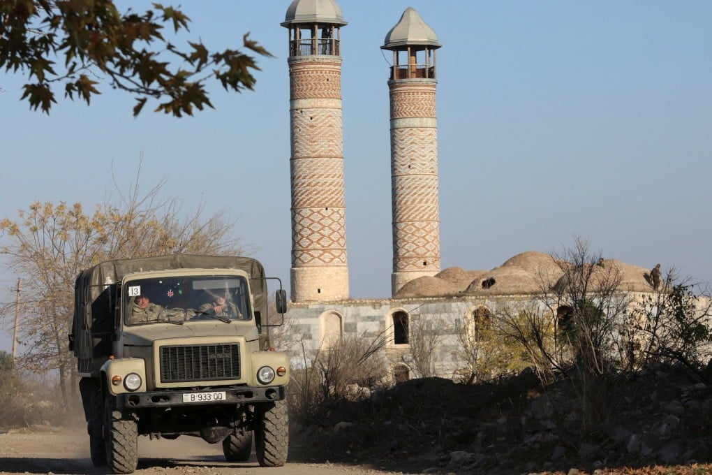 Azerbaijani soldiers drive a truck near a mosque in Agdam in the Karabakh region in 2020. Photo: Reuters