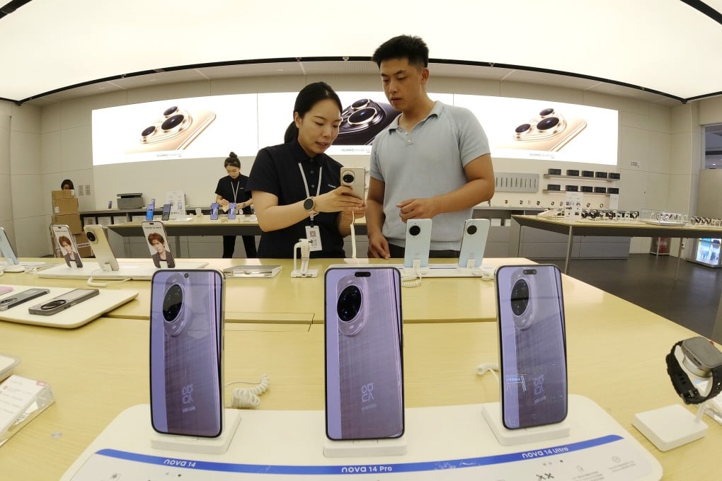 A customer checks out a mobile phone at a store in Binzhou City, in China’s Shandong province, on August 9. Photo: Xinhua