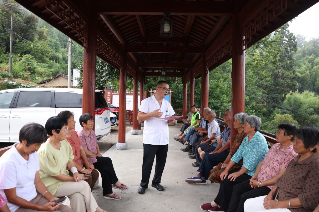 A doctor shares healthcare knowledge with elderly villagers in Libao village, Zhejiang province on July 8. Most seniors in China take a reactive approach to health and fitness and tend to address issues only when they arise. Photo: Xinhua