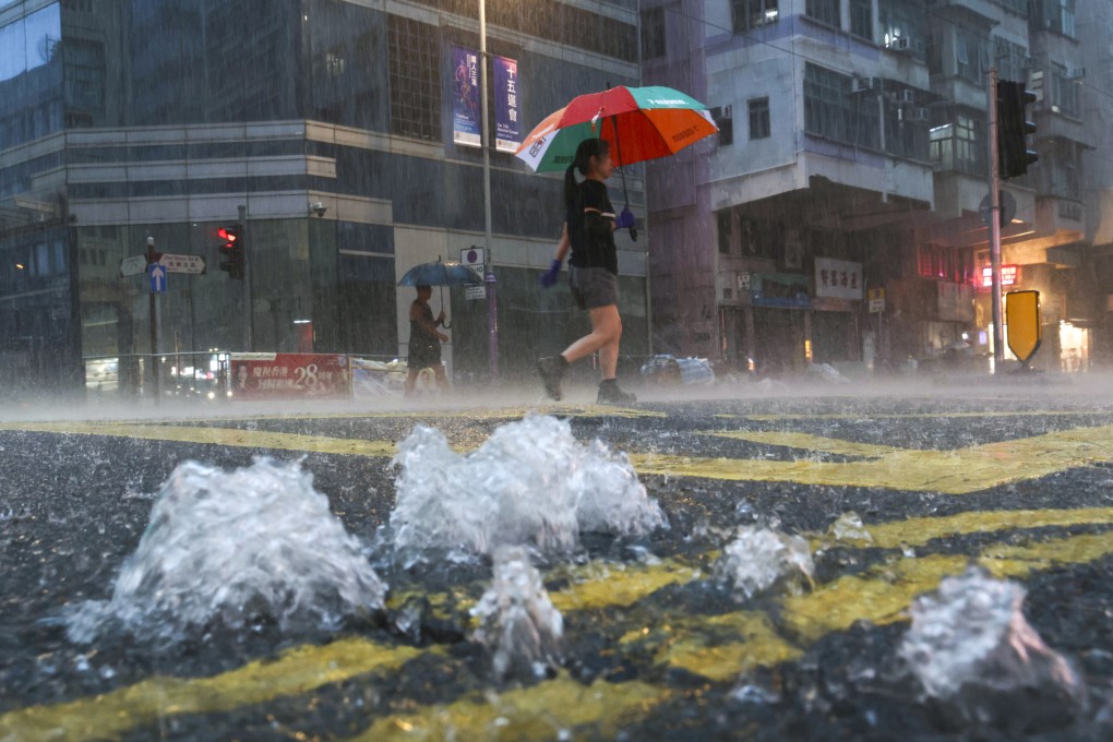 Residents in Sai Ying Pun cross a flooded road during a black rainstorm earlier this month. Photo: Karma Lo