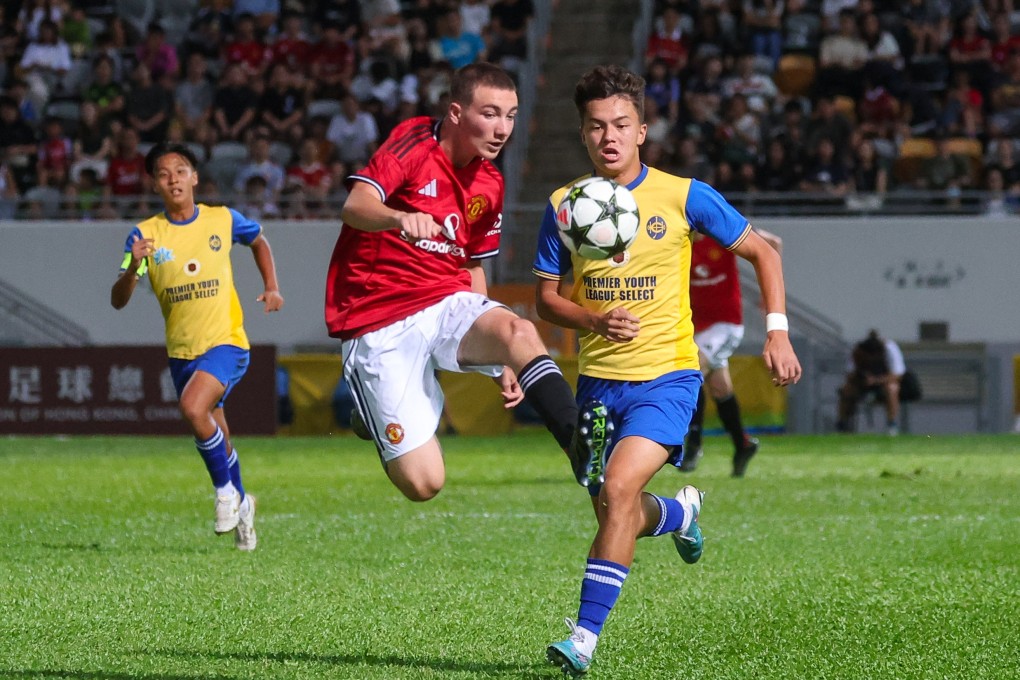 Manchester United ‘s Samuel (left) is pursued by Hong Kong’s Calum Howard in their match at Mong Kok on Friday. Photo: Edmond So