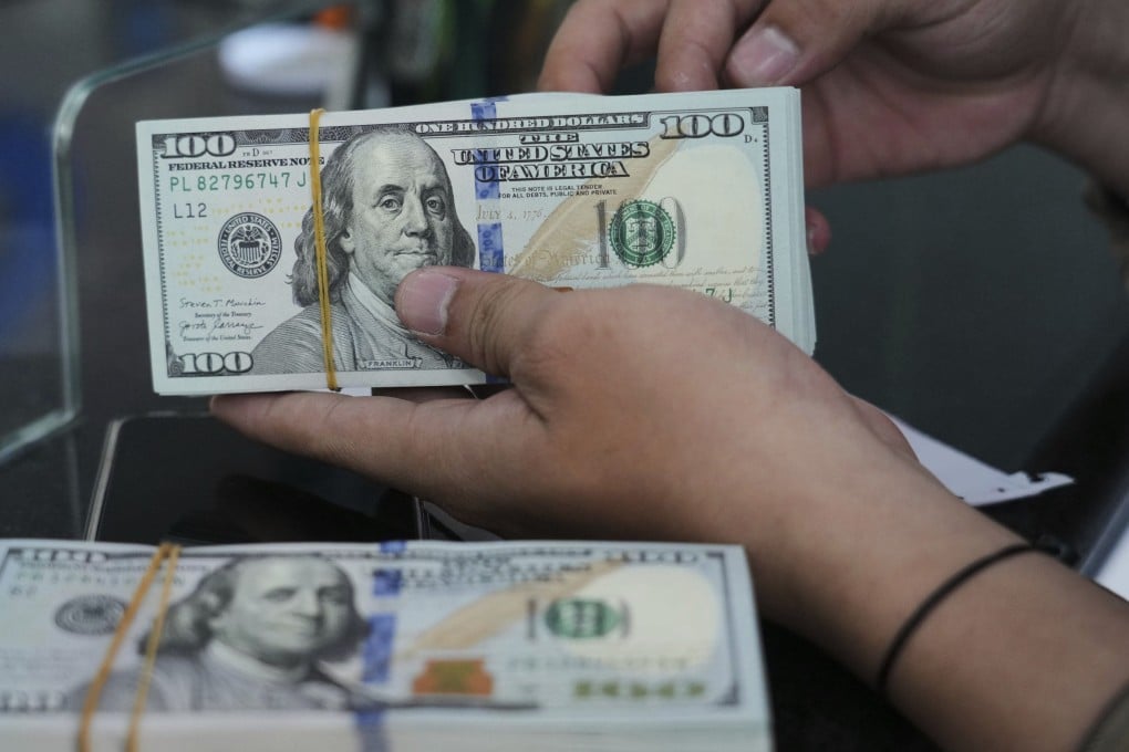 An employee counts US dollar bank notes at a money changer in Jakarta. SMEs often operate on thin margins and require steady cash flows to survive. Photo: AP