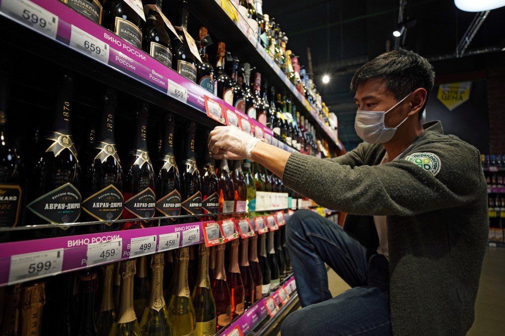A worker arranges bottles of Russian sparkling wine at a supermarket in Moscow. Photo: Reuters