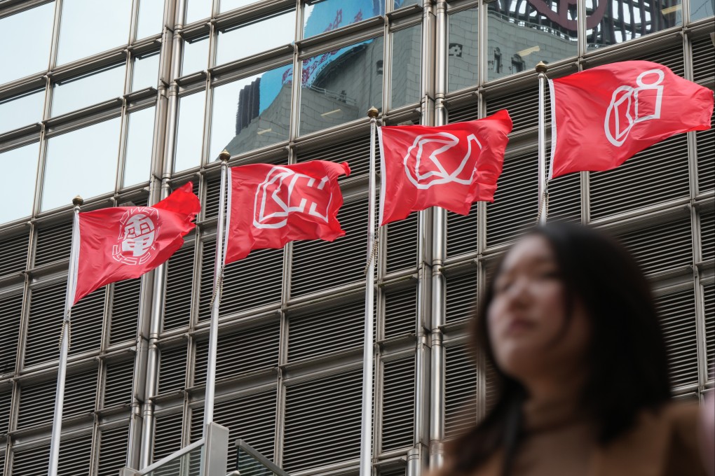 A woman seen in front of a row of CK Hutchison flags in Central, Hong Kong, March 18 2025. Photo: Sam Tsang