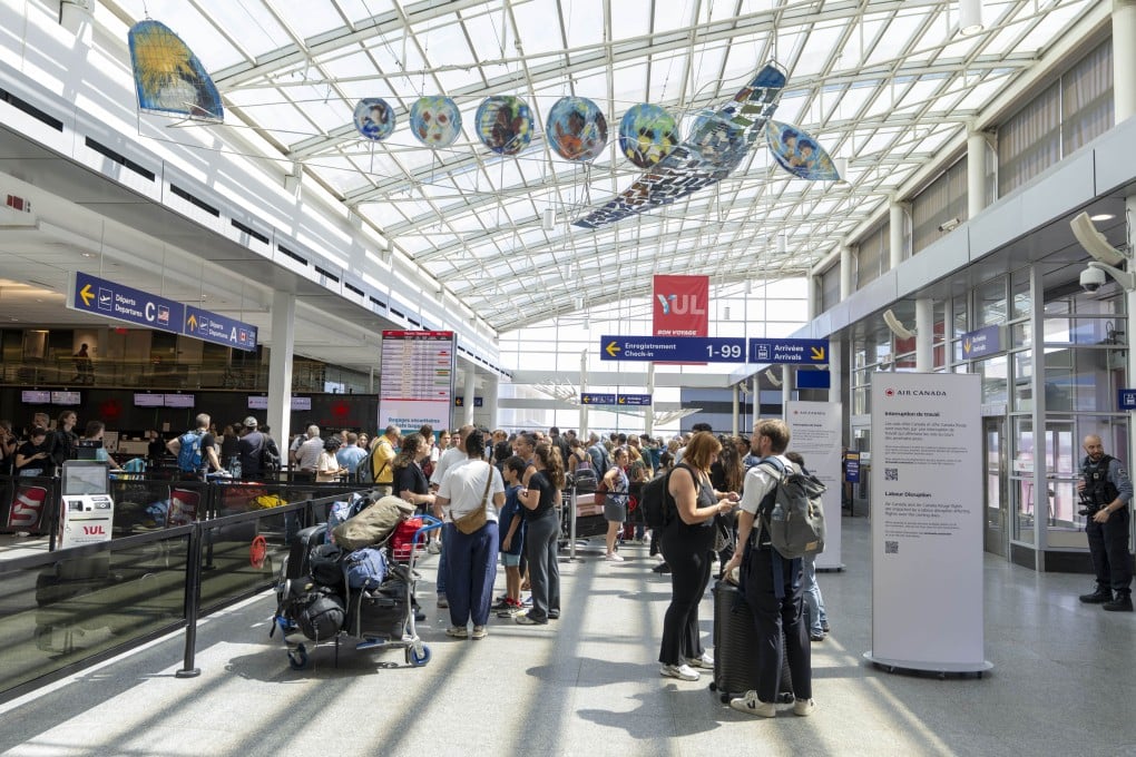 Travellers wait in line at the Air Canada counter in Montreal-Pierre Elliott Trudeau International Airport in Dorval, Quebec, on August 15. Photo: The Canadian Press via AP