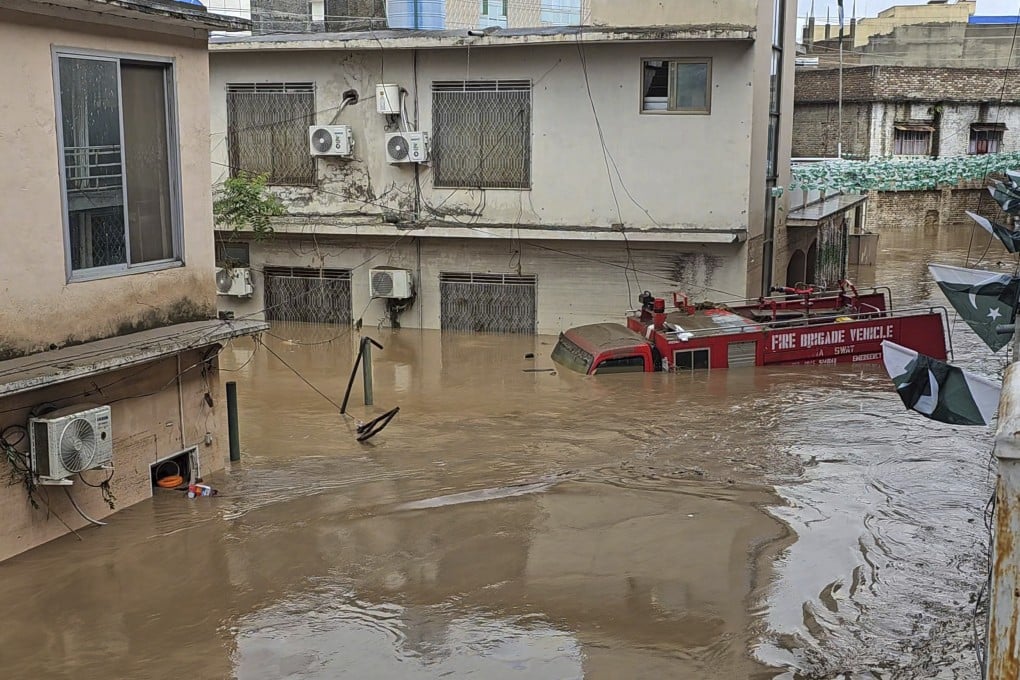 A fire engine is sugmerged in floodwaters following heavy rains in Mingora, the main town of Swat Valley in Pakistan on Friday. Photo: AP