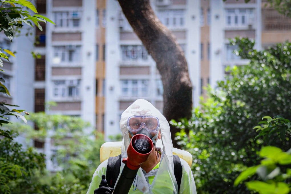 A worker from the Food and Environmental Hygiene Department sprays chemicals to suppress the growth of Aedes mosquitos in Lei Tung Estate. Photo: Karma Lo