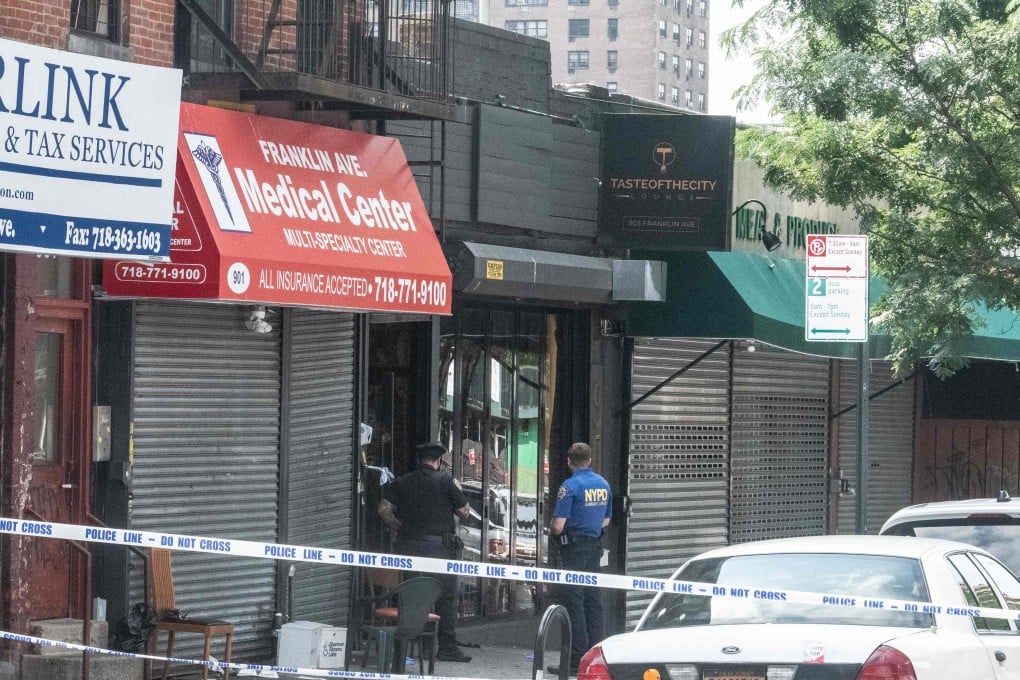 New York Police Department (NYPD) officers investigate a shooting at Taste of the City lounge in the Crown Heights neighbourhood of Brooklyn, New York on Sunday. Photo: Getty Images via AFP