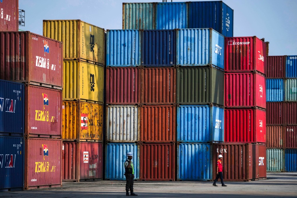 A worker walks near shipping containers at IPC Container Terminal at Tanjung Priok Port in Jakarta, Indonesia, on August 6. Photo: AP