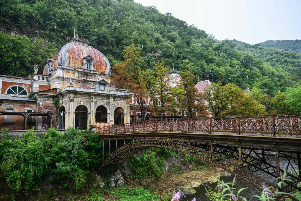 The Neptune Imperial Baths building and the wrought iron bridge that is closed for access in Baile Herculane, Romania, on July 29. Photo: AFP