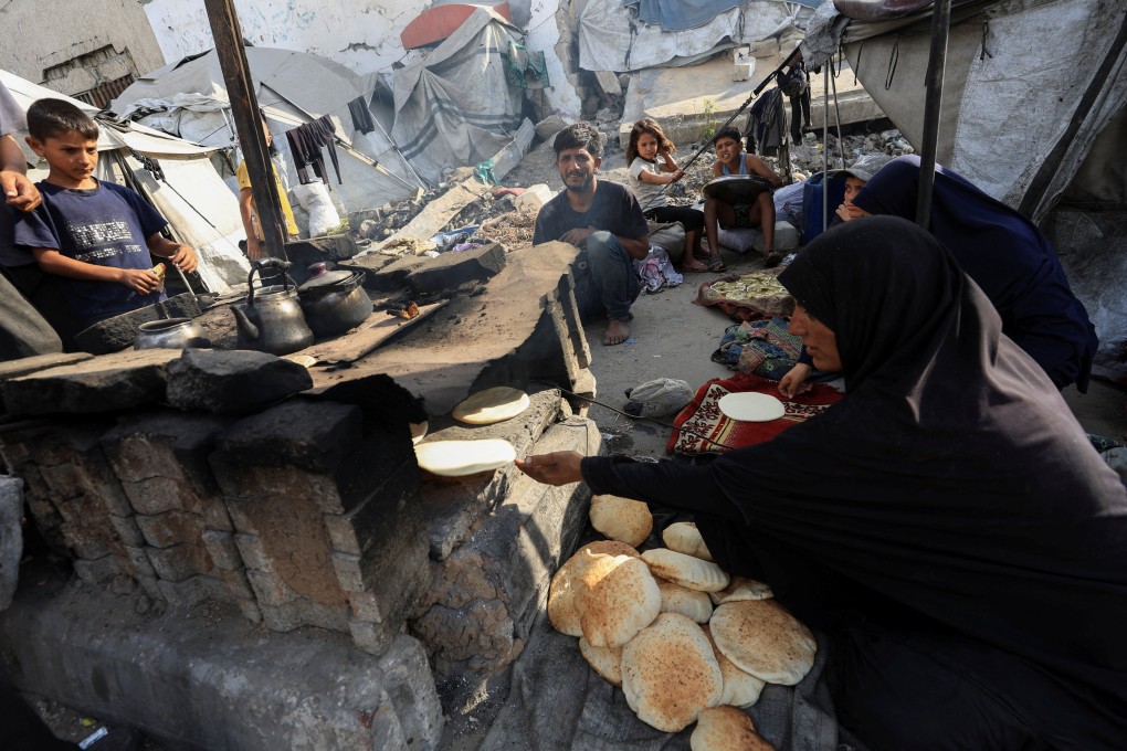 A displaced Palestinian family bakes bread at a tent camp where they shelter, as the Israeli military prepares to relocate residents to southern Gaza, in Gaza City, on Monday. Photo: Reuters