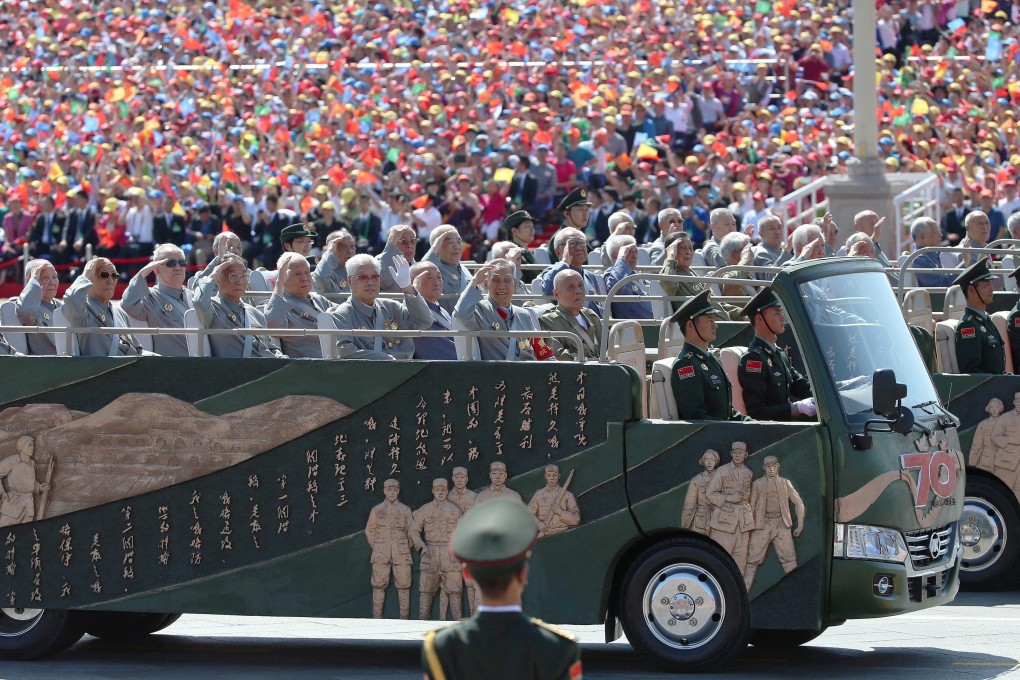 Veterans salute as they ride through Tiananmen Square in Beijing during a military parade on September 2, 2015, marking the 70th anniversary of China’s victory against Japan. Photo: EPA