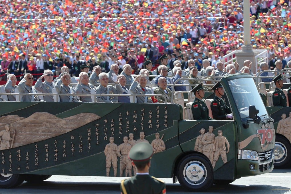 Veterans salute as they ride through Tiananmen Square in Beijing during a military parade on September 2, 2015, marking the 70th anniversary of China’s victory against Japan. Photo: EPA