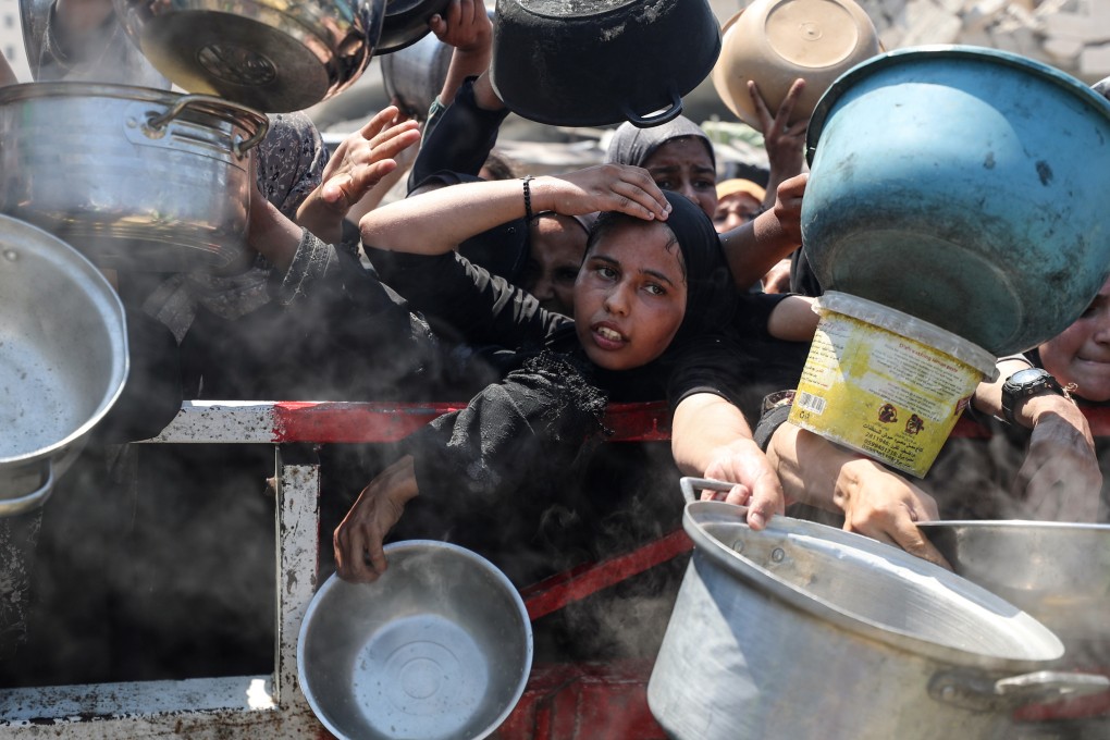 Palestinians wait for a meal distributed by a charity organisation in Gaza on July 30. Photo: Zuma Press Wire/dpa