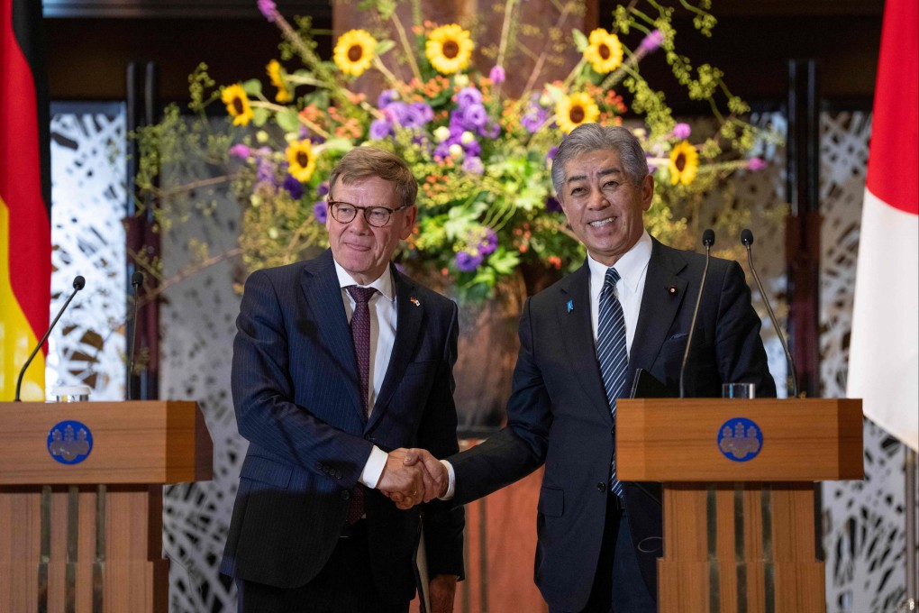 Japan’s Foreign Minister Takeshi Iwaya and his German counterpart Johann Wadephul shake hands following a joint press conference at the Iikura Guest House in Tokyo on Monday. Photo: AFP
