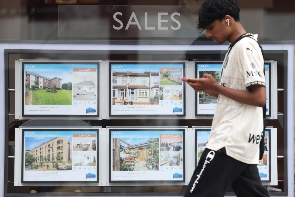 A person walks past an estate agent’s properties listing in London, on August 7. The average home prices fell by 1.3 per cent this month. Photo: EPA