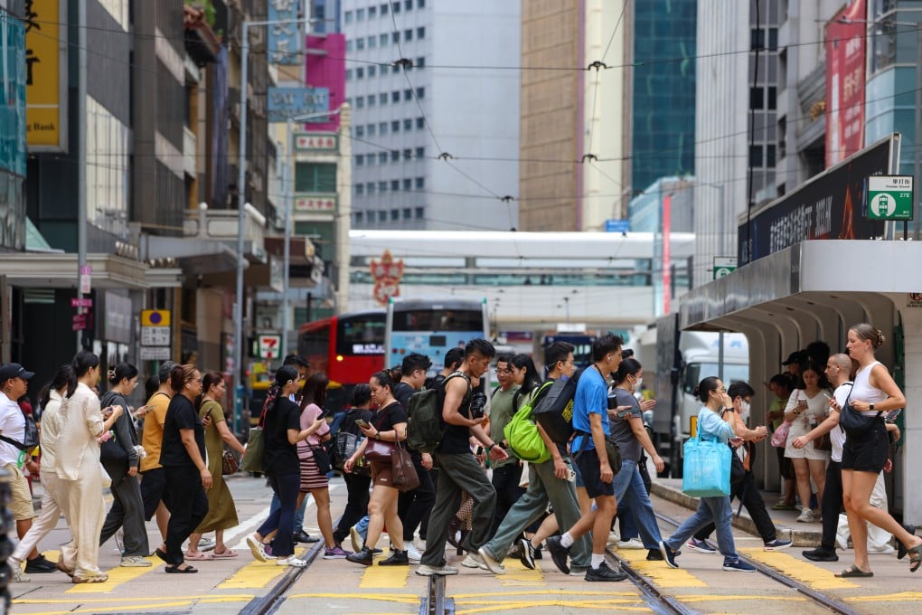 Pedestrians cross a road in Central on August 15, 2025. Photo: Jelly Tse
