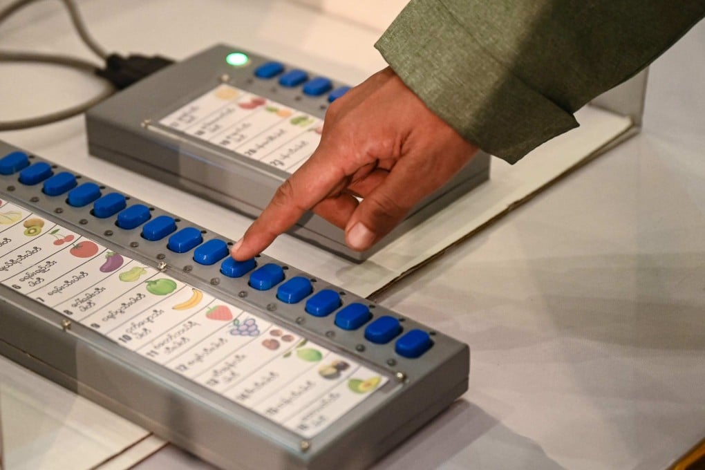 A Myanmese official shows how to use a voting machine for elections in Yangon. Photo: AFP