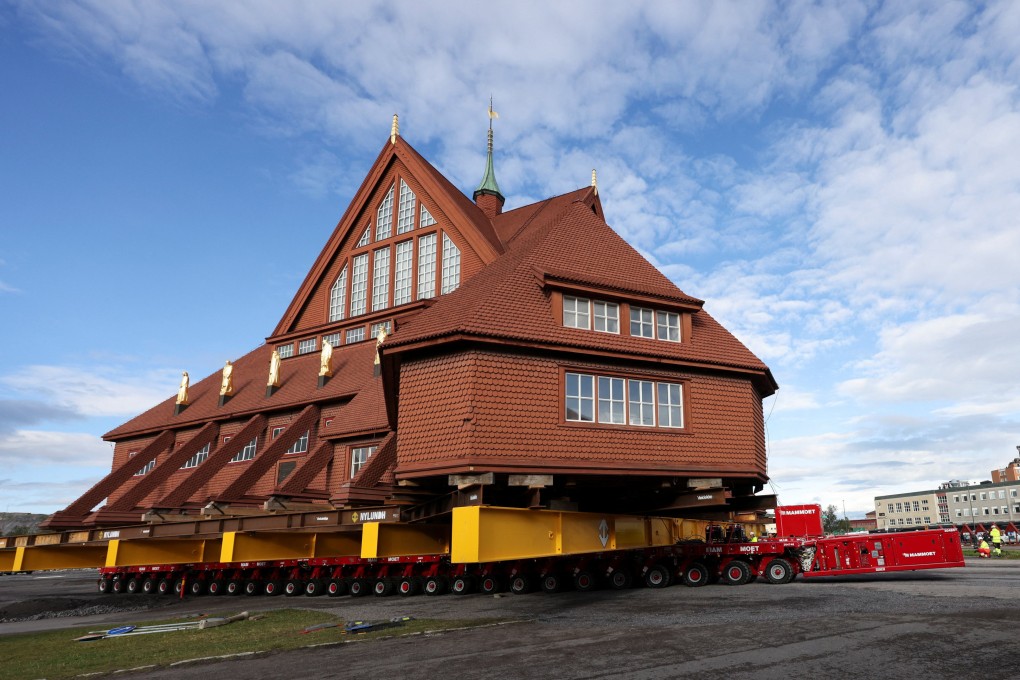 A worker stands as Kiruna’s old wooden church is moved during a two-day relocation trip to save its wooden walls from ground subsidence and the expansion of the world’s largest underground iron ore mine. Photo: Reuters