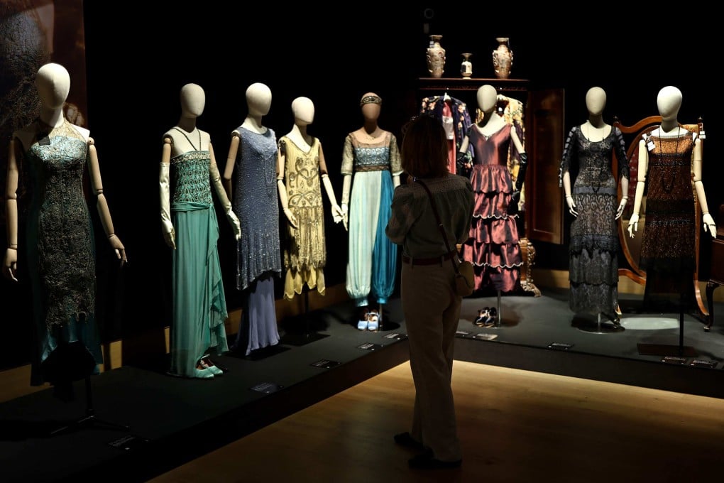 A person looks at a collection of dresses, belonging to characters from Downton Abbey, at an exhibition in London before props and costumes from the franchise go on auction. Photo: AFP