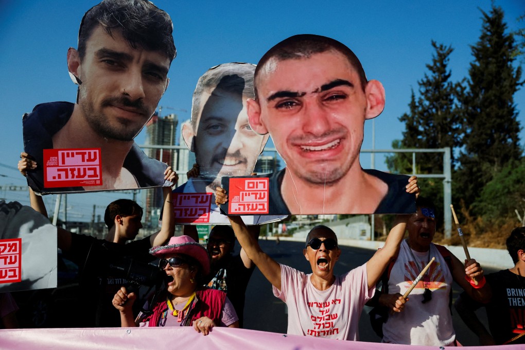 Protesters in Tel Aviv on Tuesday hold pictures of hostages as they block a road during a demonstration demanding the immediate end of the war in Gaza and the release of all hostages. Photo: Reuters