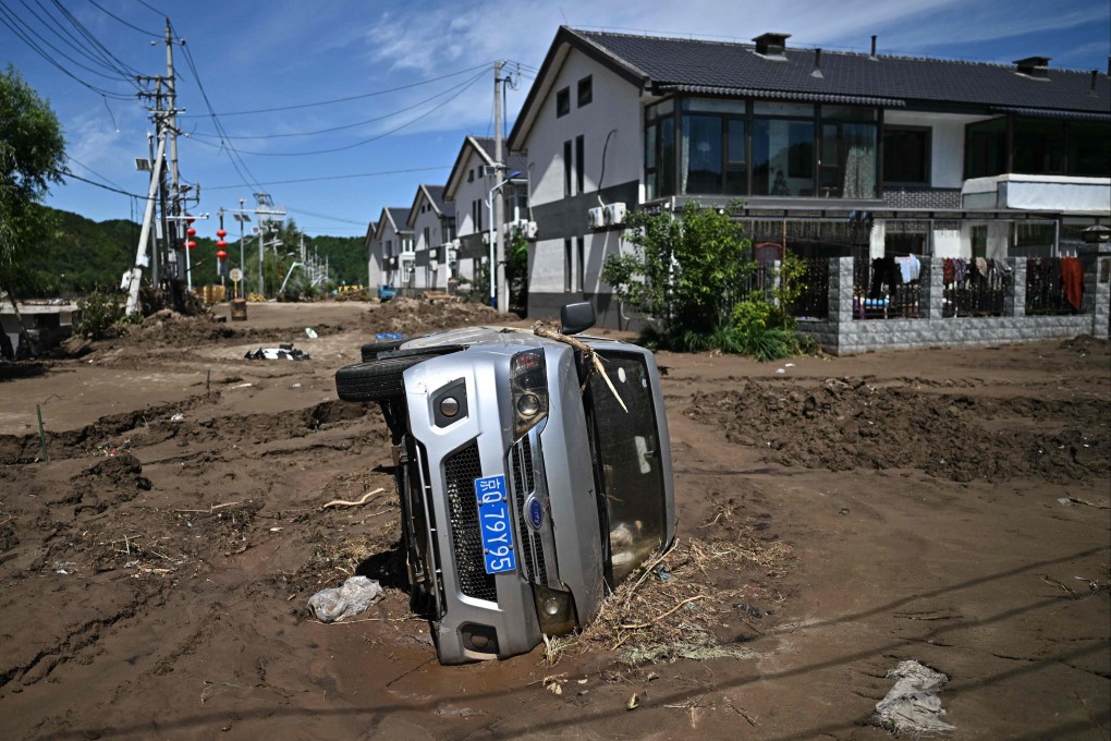 A flood-damaged car is seen following heavy rains in Huairou district, on the outskirts of Beijing, on July 30. Scientists warn that the intensity and frequency of global extreme weather events will increase as the planet continues to heat up because of fossil fuel emissions. Photo: AFP
