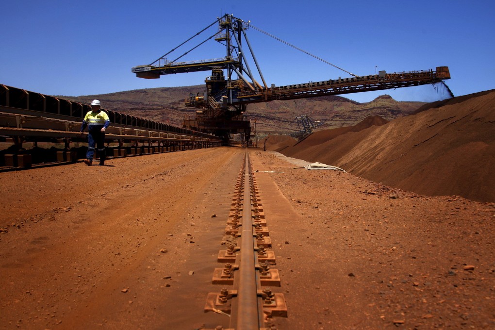 A mine worker inspects conveyer belts transporting iron ore at the Fortescue Solomon iron ore mine, in the Sheila Valley, around 400km south of Port Hedland, in the Pilbara region of Western Australia. Photo: Reuters