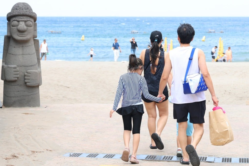 People head to the sea on Iho Tewoo Beach, Jeju. Photo: EPA-EFE/Yonhap