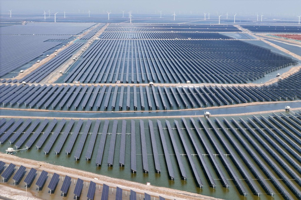 Solar panels and wind turbines are seen at the Huaneng Binzhou new energy power generation project in Binzhou, in China’s eastern Shandong province, on June 11. Photo: AFP