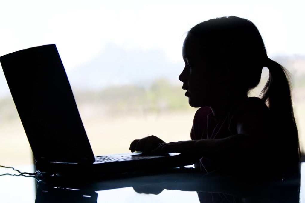 Silhouette of a young girl on the computer. A 12-year-old girl in Malaysia was found to be running a WhatsApp group peddling pornographic photos. Photo: Shutterstock