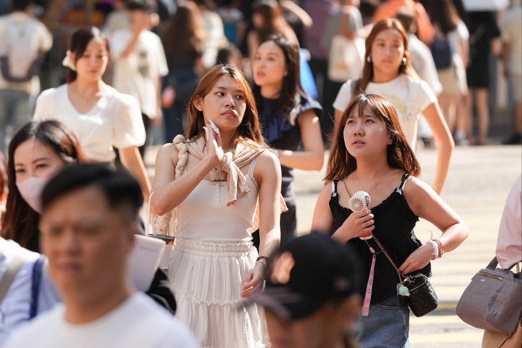 Pedestrians in Causeway Bay try to keep cool amid sweltering heat on Wednesday afternoon. Photo: Eugene Lee