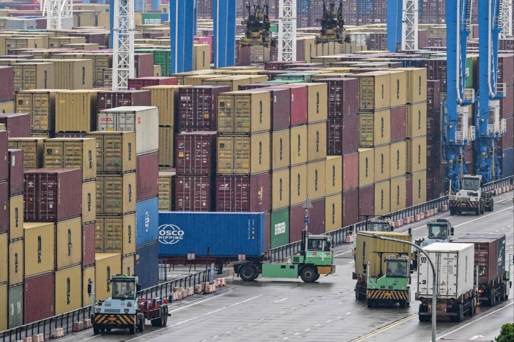 Trucks drive past containers at the Port of Ningbo-Zhoushan in Ningbo, Zhejiang province, in late May. Photo: AFP