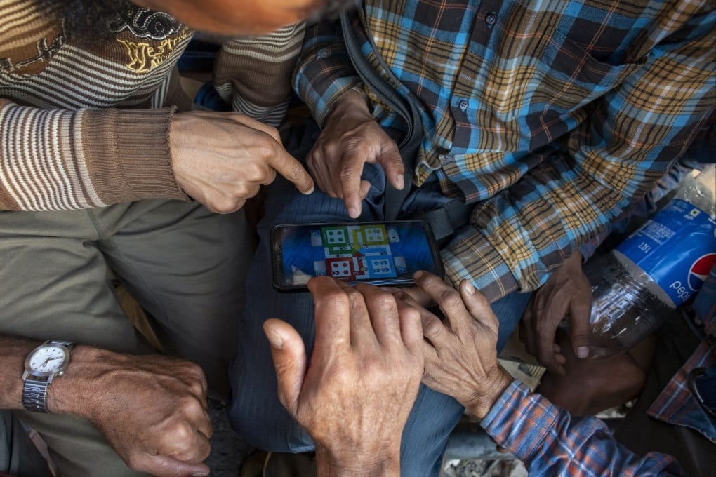 Porters play a game of Ludo online. Companies may challenge India’s new online gaming law, claiming it unjustly targets skill-based games. Photo: AP
