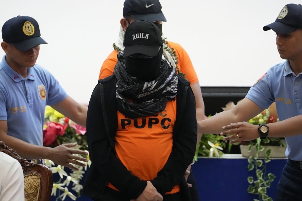 A heavily masked Apollo Quiboloy (centre) is escorted to a press conference in Quezon City on September 9, last year. Photo: AP