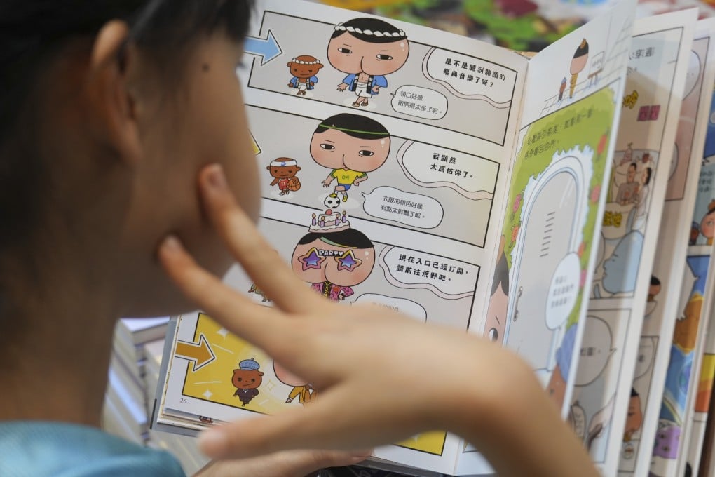 A child reads a comic book at the Hong Kong Book Fair in July. Malaysian authorities are hoping comics can attract children to their anti-corruption message. Photo: Sam Tsang