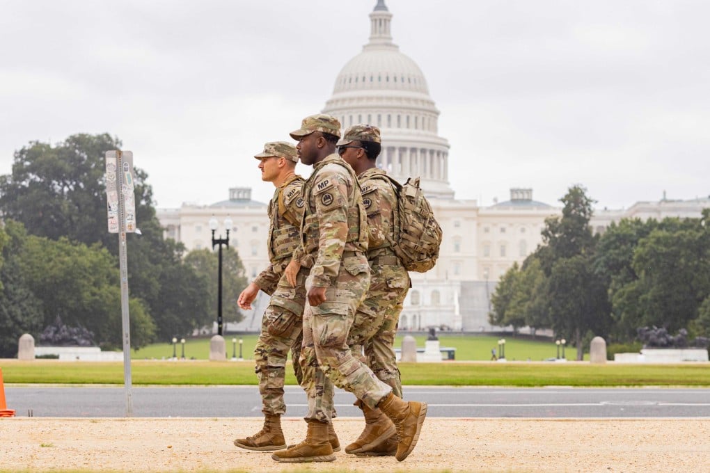 Members of the National Guard walk past the Capitol building in Washington. Photo: dpa