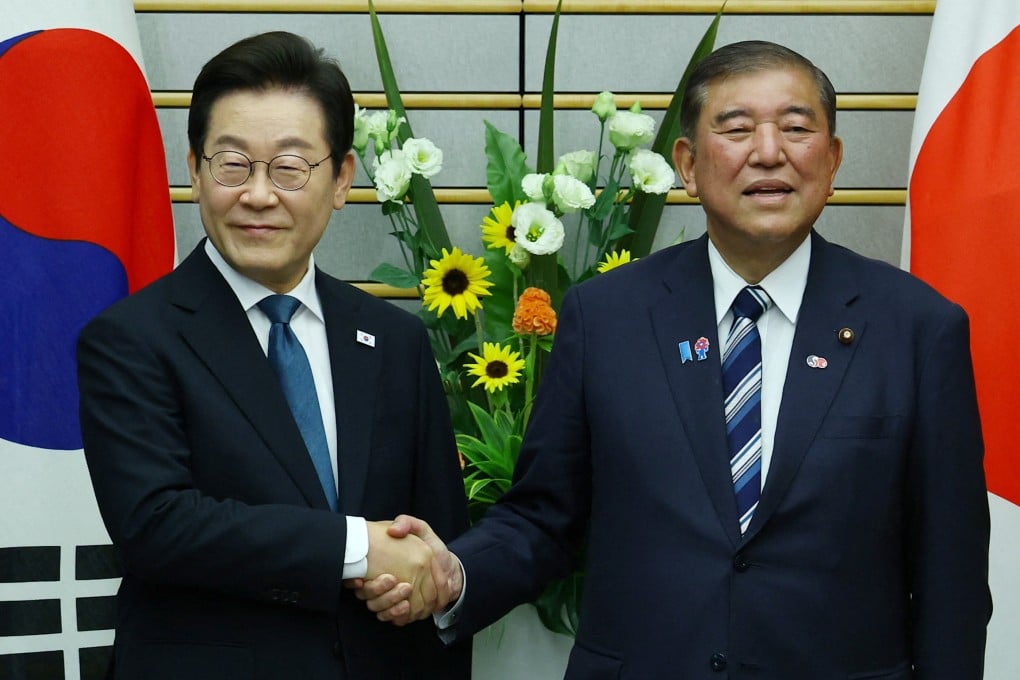 South Korea’s President Lee Jae-myung (left) shakes hands with Japan’s Prime Minister Shigeru Ishiba in Tokyo, Japan on Saturday. Photo: Reuters