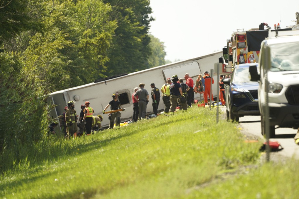 First responders work to rescue victims at the scene of a tour bus that crashed and rolled over on the New York State Thruway near Pembroke, New York, on Friday. Photo: Buffalo News via AP