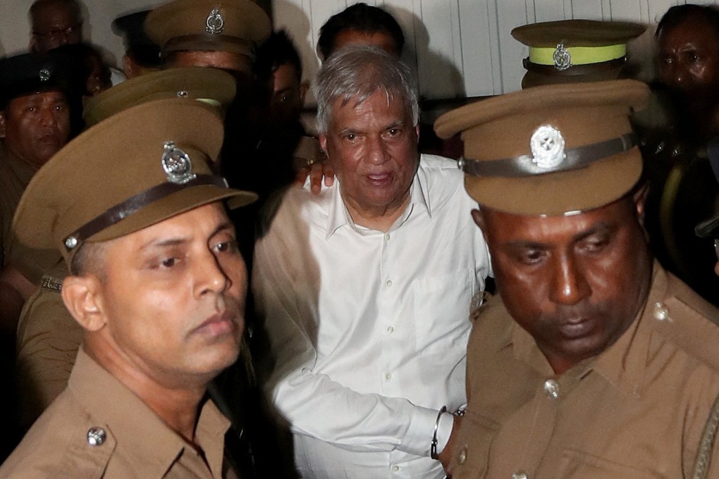 Sri Lanka’s former President Ranil Wickremesinghe is escorted by prison and police officials as he leaves the Magistrate’s Court in Colombo, Sri Lanka on Friday. Photo: Reuters
