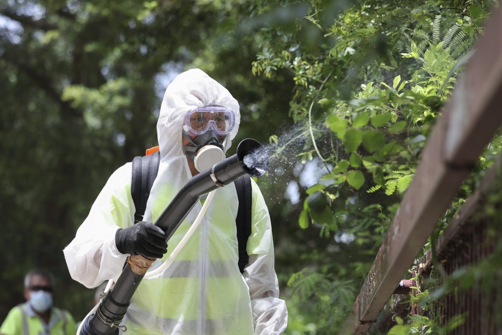 A worker from the Food and Environmental Hygiene Department carries out aedes mosquito control at Lei Tung estate on August 6. Photo: Karma Lo