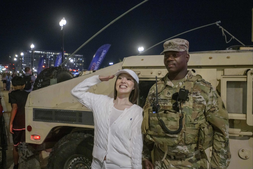 A woman poses with a member of the National Guard in Washington on August 23. Photo: AP