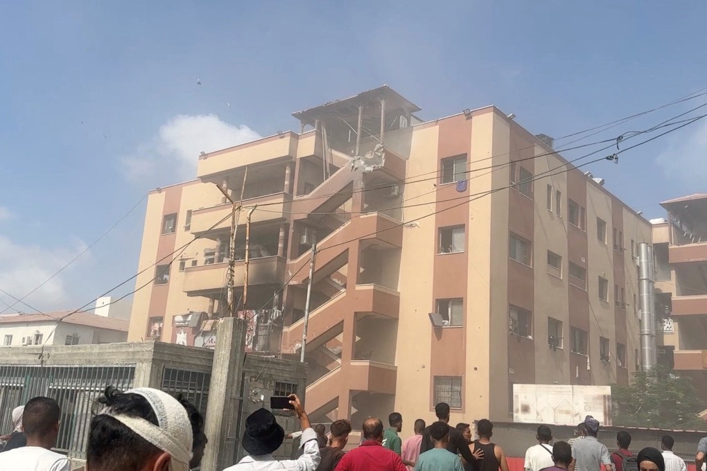 People walk at the site of Israeli strikes on Nasser hospital in Khan Younis, Gaza on Monday. Photo: Reuters