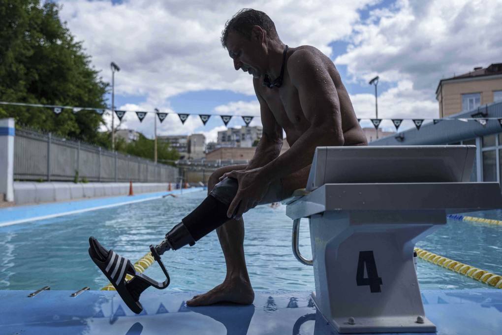 Ukrainian war veteran Pavlo Tovstyk removes his prosthetic leg in Kyiv, on August 12, 2025, as he prepares to train for the race across the Bosporus Strait. Photo: AP