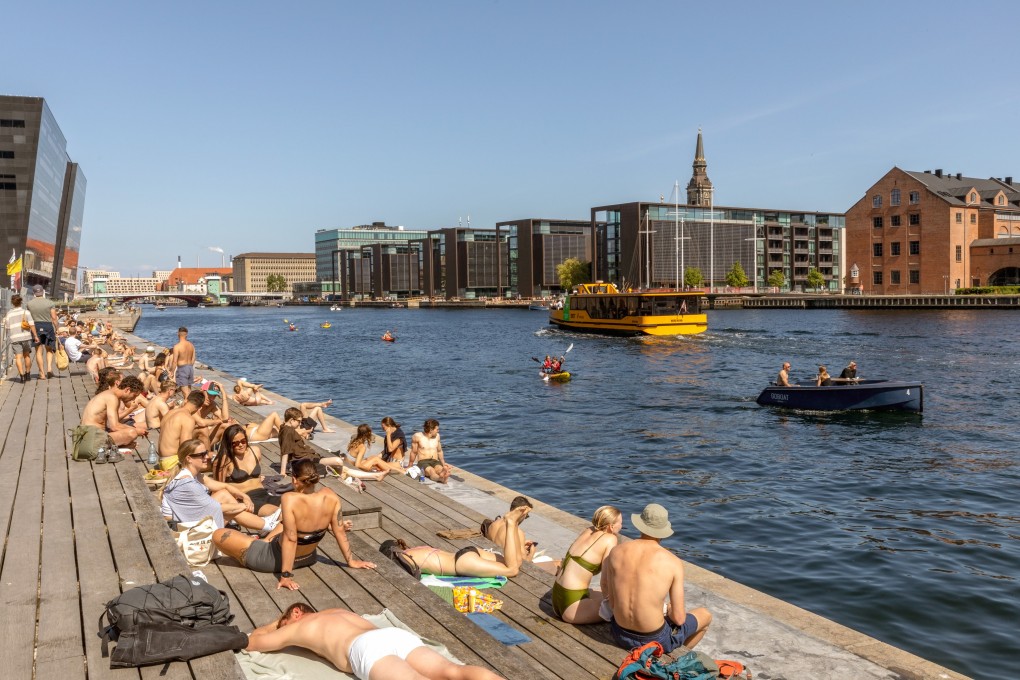 Sunbathers near the Royal Library in Copenhagen, beside a harbour that is clean enough to swim in. Photo: Getty Images