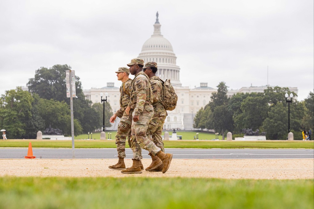 Members of the US National Guard walk past the Capitol building in Washington. US President Donald Trump has threatened to expand his military deployments to Baltimore, Maryland. Photo: Zuma Press Wire / dpa