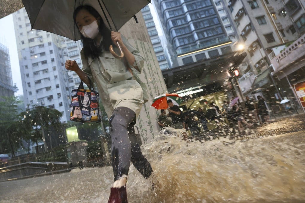 Pedestrians brave the rain under a black rainstorm warning at Hill Road in Hong Kong’s Shek Tong Tsui, August 14, 2025. Photo: Karma Lo