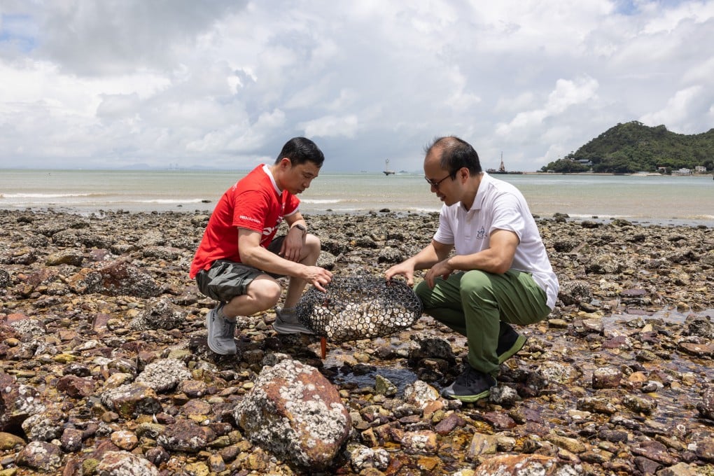 Willy Kwong (right), director of A Plastic Ocean Foundation, explains how oyster bags have an impact on shoreline restoration.