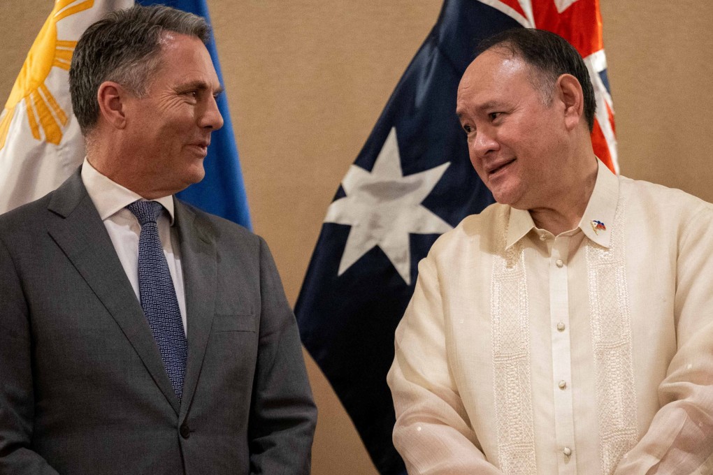 Australian Defence Minister Richard Marles (left) and his Philippine counterpart, Gilberto Teodoro Jnr, talk after their joint press briefing in Makati City on Friday. Photo: Reuters
